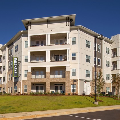 Exterior view of the Ballpark Apartments @ Town Madison with their sign on the side of the building